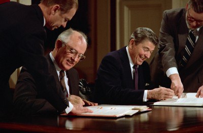08 Dec 1987, Washington, DC, USA --- President Ronald Reagan and Soviet General Secretary Mikhail Gorbachev signing the arms control agreement banning the use of intermediate-range nuclear missles, the Intermediate Nuclear Forces Reduction Treaty. --- Image by © Bettmann/CORBIS